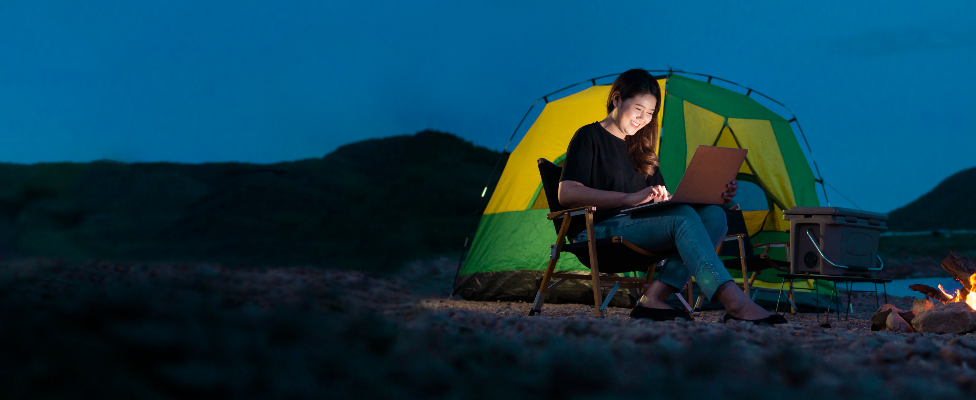 Person working in a hybrid environment, a campsite
