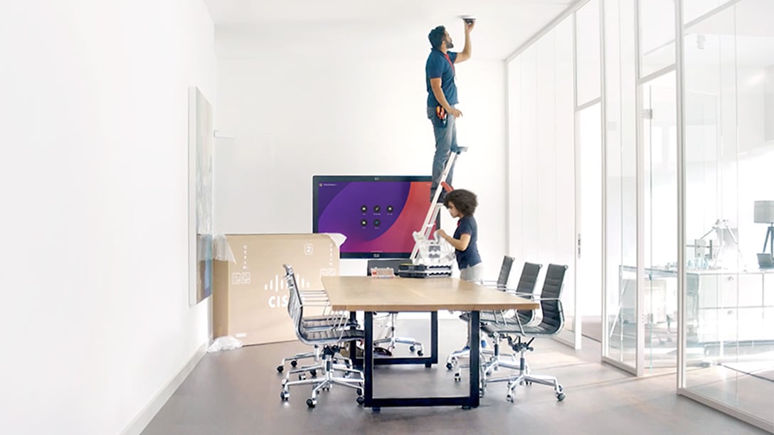Workplace meeting featuring in person and over video hybrid teamwork