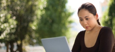 Woman in a park using a laptop