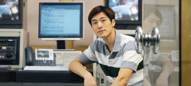 Young Asian man sitting in front of a computer