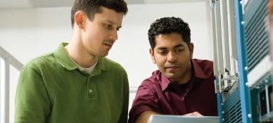 Two men looking at a laptop screen