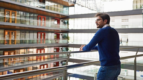 Man looking out over balcony