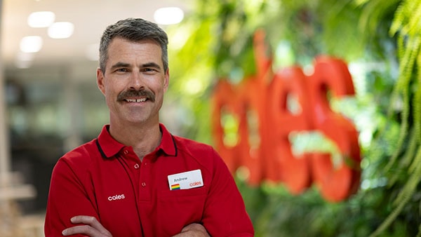 Andrew Greaney of Coles standing in store