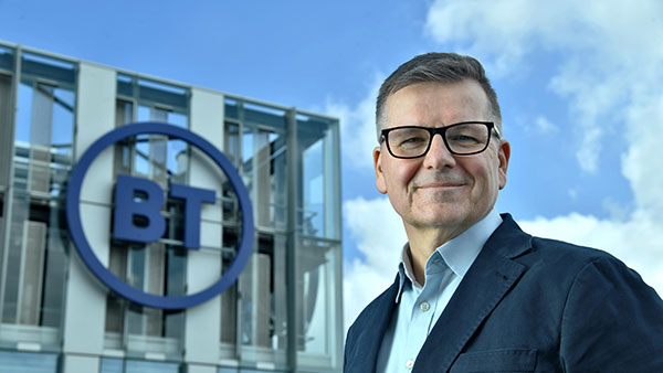 Colin Bannon looking out towards roof view with BT building in background