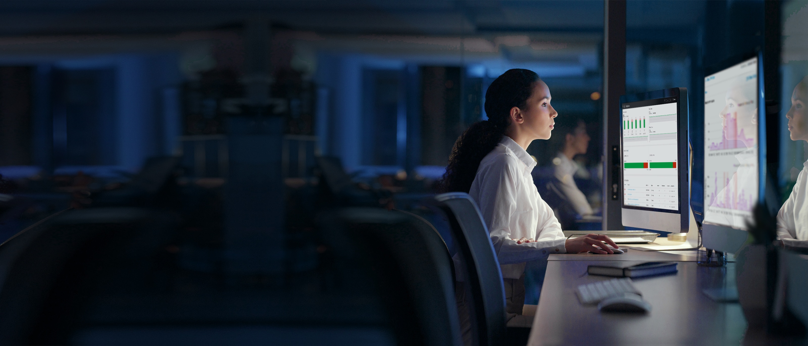 Office worker viewing double computer screens