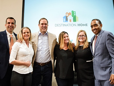 Image of Chuck Robbins with people from Destination Home