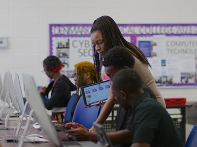 Image of a teacher helping a student